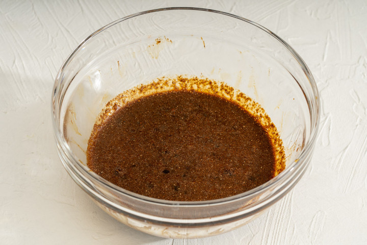 The seasoning sauce for garlic chili oil mixed together in a glass bowl.