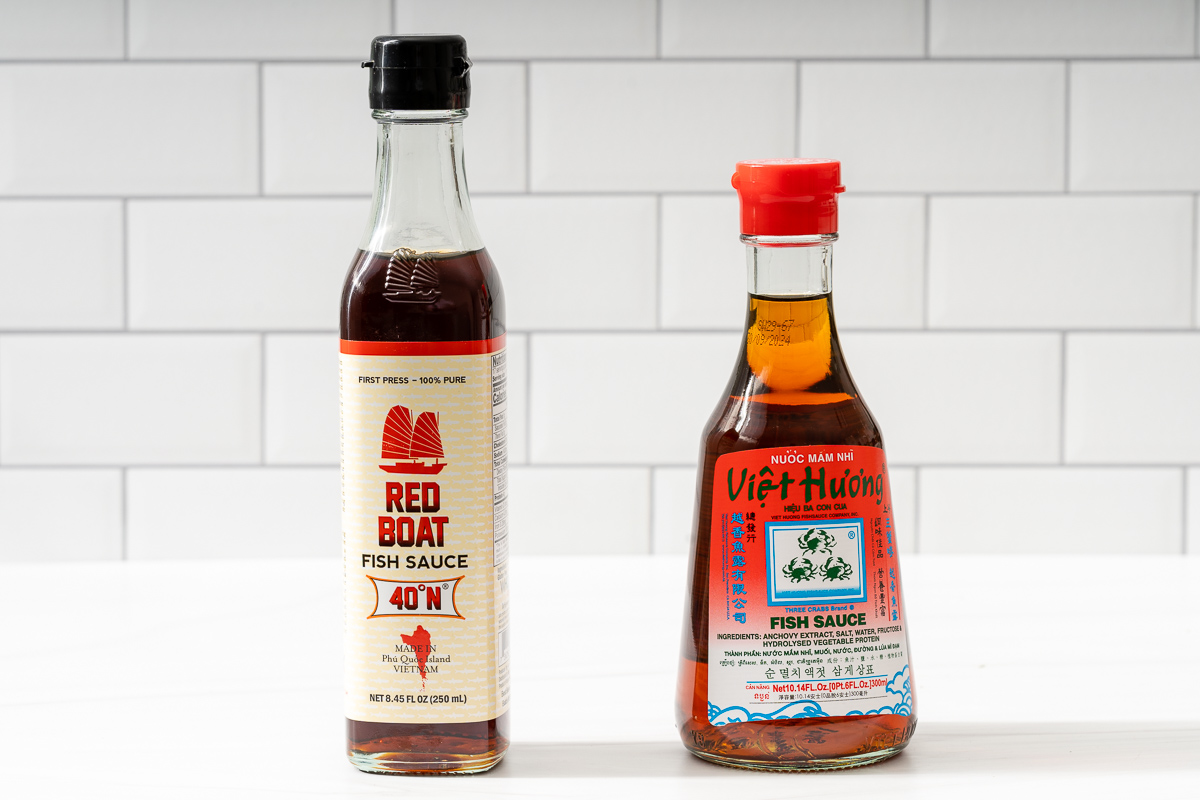 Two bottles of popular fish sauce brands next to each.