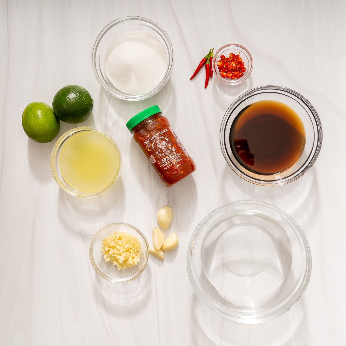The various ingredients for nuoc cham laid out in respective mixing bowls.