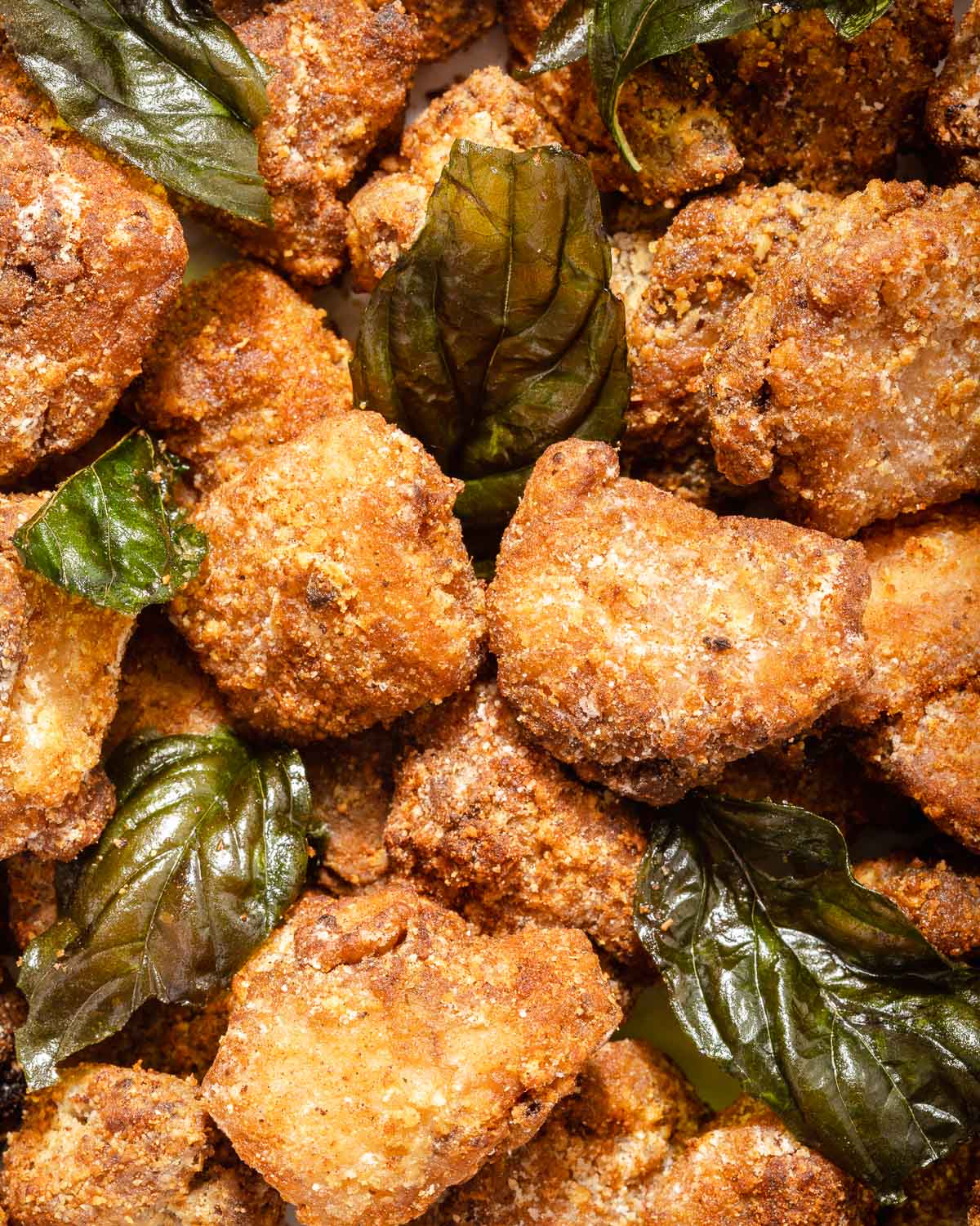 A detail shot Taiwanese fried Chicken tossed with fried basil.