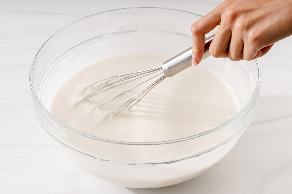 Mixing together the wet batter in a large mixing bowl.