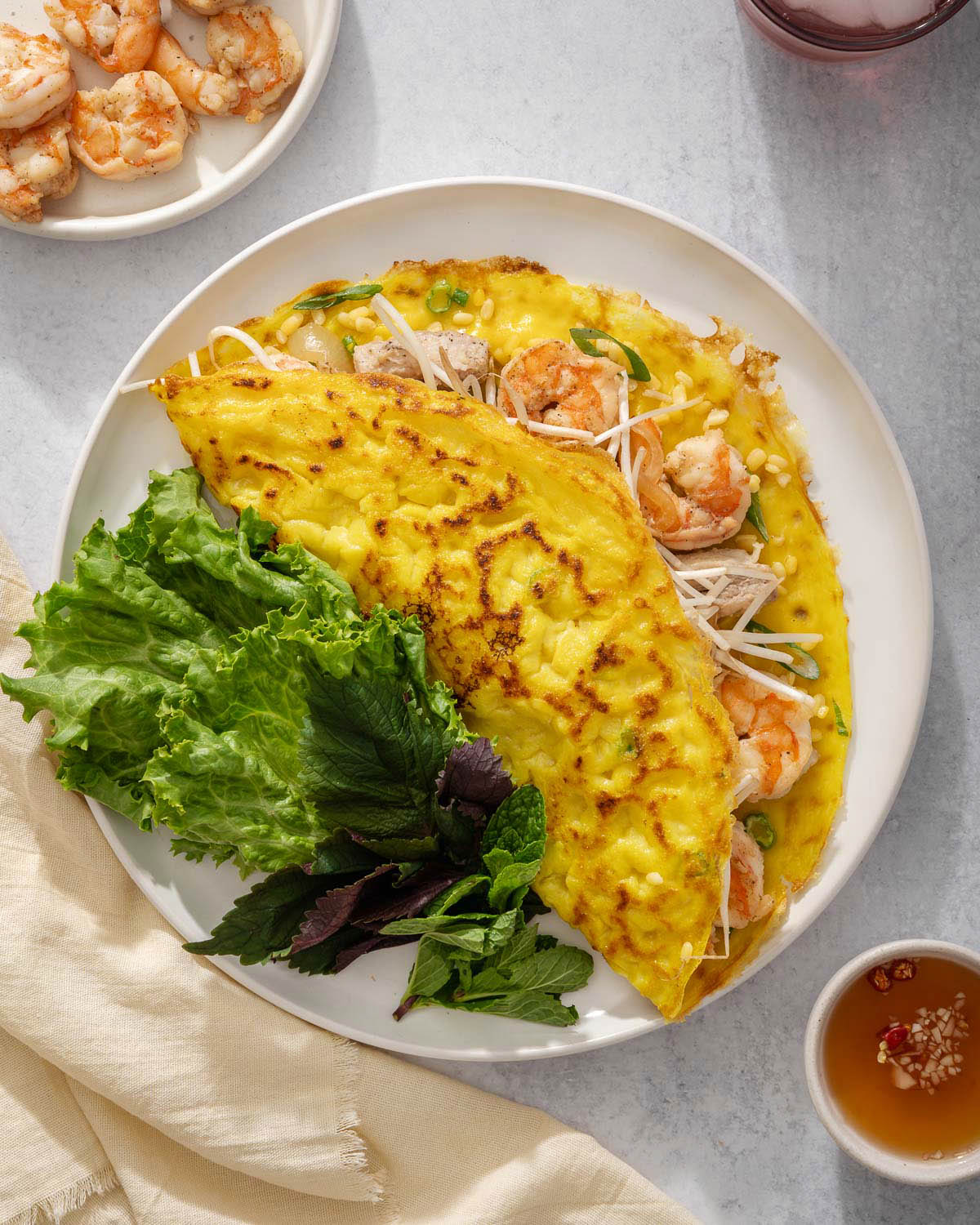 Looking down at a plate of banh xeo Vietnamese crepe.
