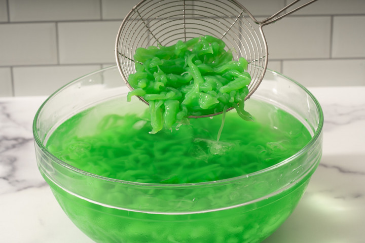 Sifting pandan jelly from an ice bath.