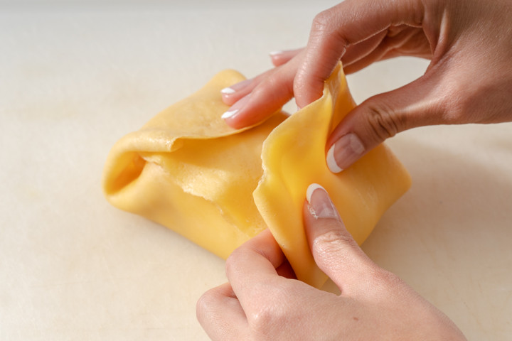 Completing the mango pancake folding.