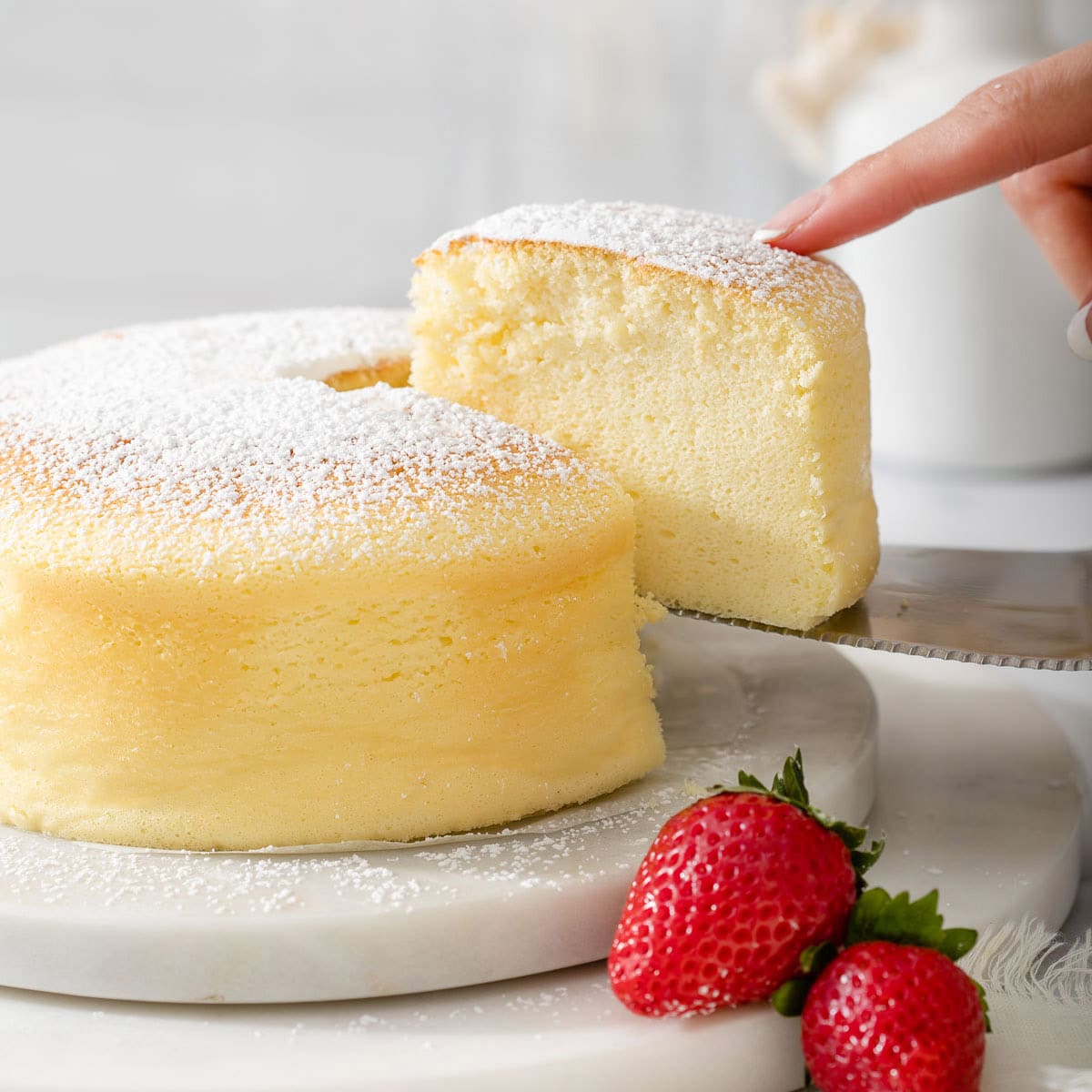 Someone slicing a piece of Japanese cotton cheesecake.