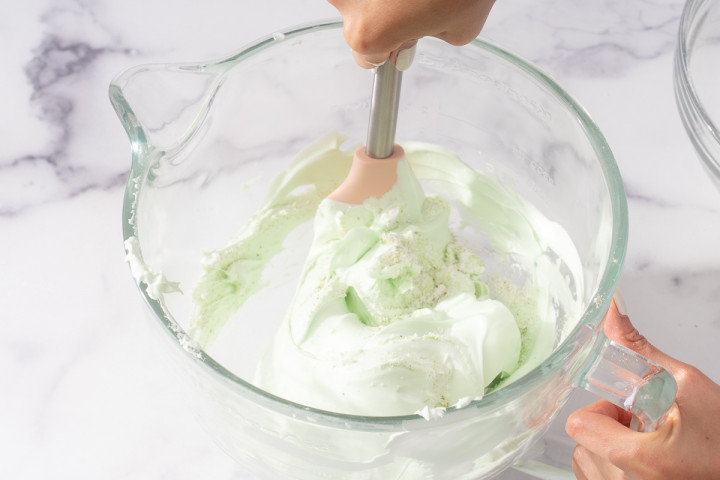 Folding together the dry ingredients into the meringue.