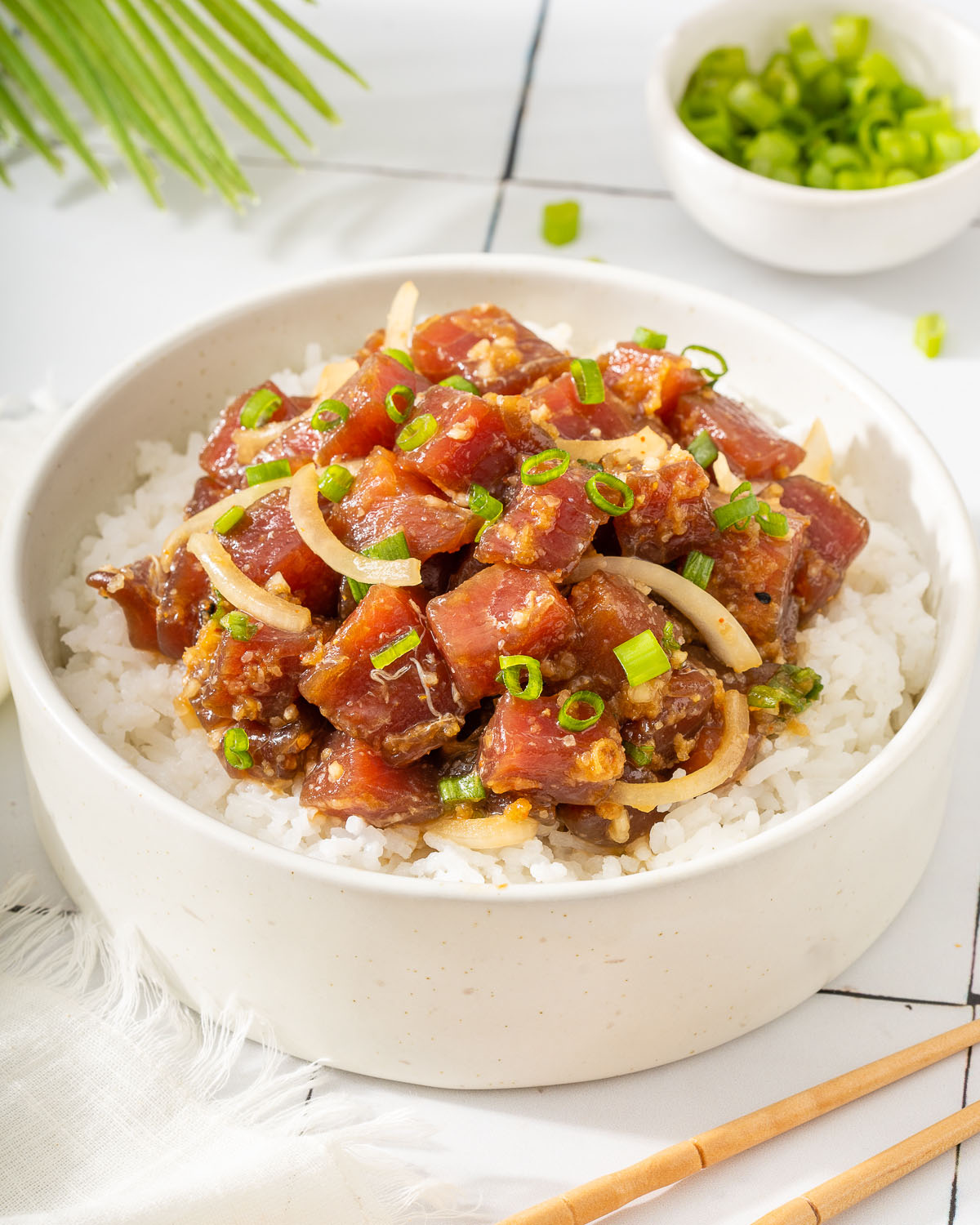 Up close of A Hawaiian poke bowl on a bed of rice.