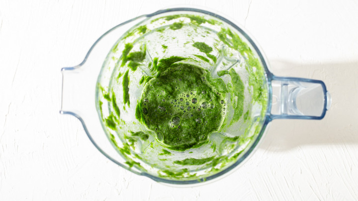 Pandan leaves pulverized in a blender.