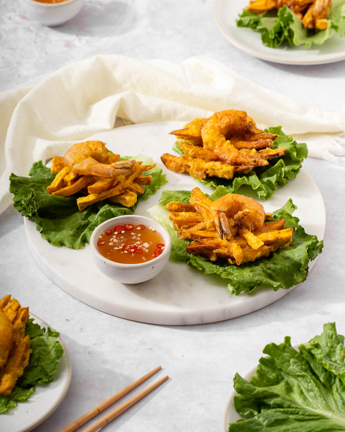 A few Vietnamese shrimp and sweet potato fritters on a serving platter.
