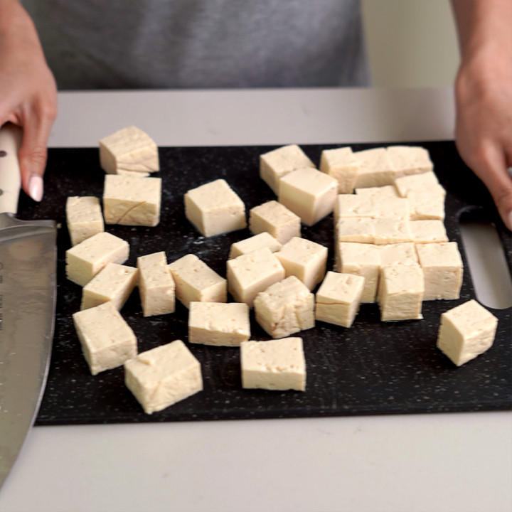 A block of tofu cut up into cubes.