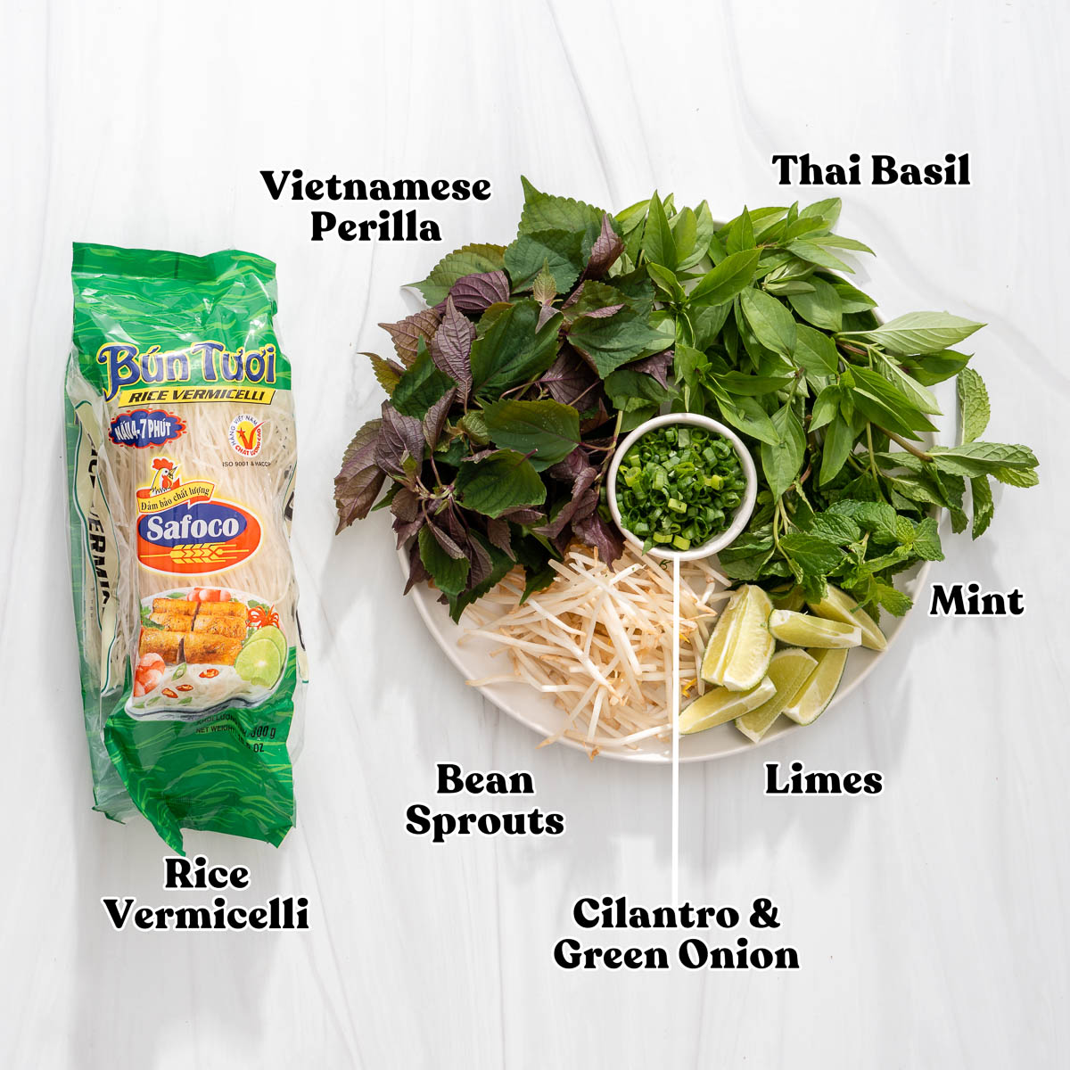 All the fresh herbs and noodles to serve with Vietnamese crab and tomato soup.