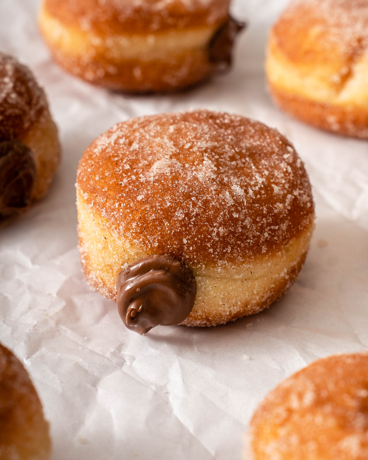 Up close of a milk bread nutella donut on a parchment paper.