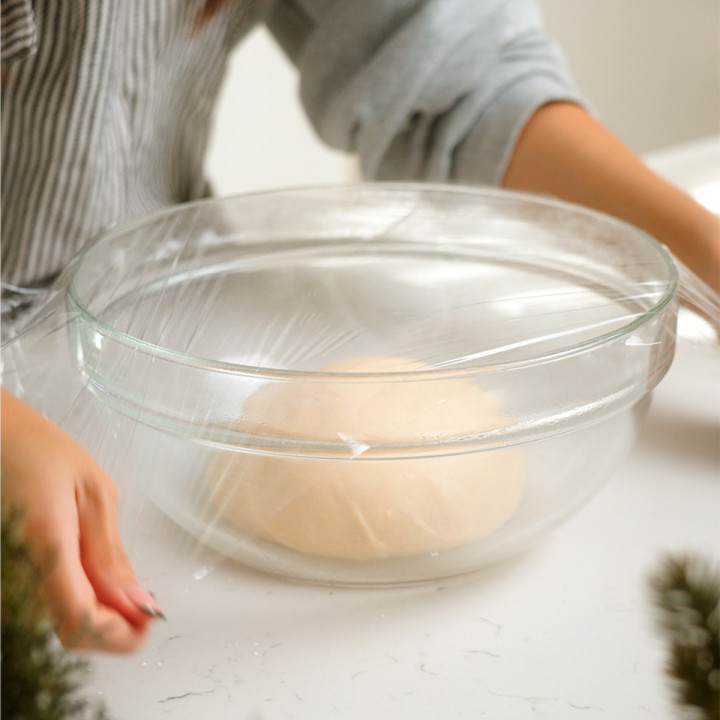 Wrapping the bowl with the dough to proof and rise.