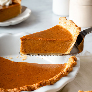 Up close of a slice of sweet potato pie being lifted from a pie dish.