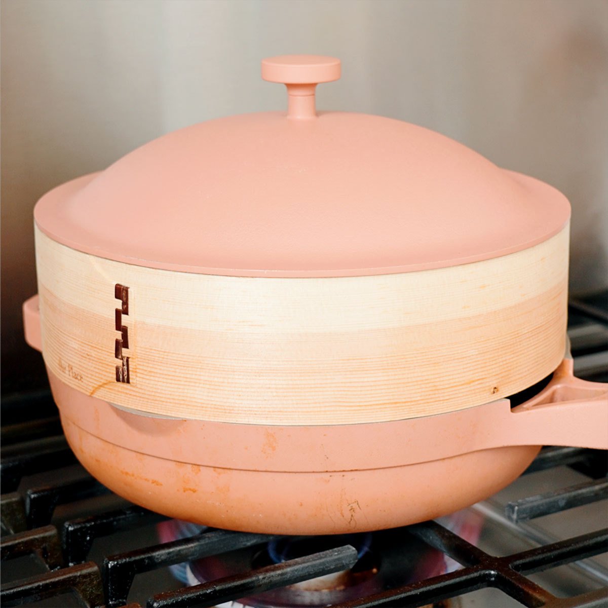 Steaming the xoi gac sticky rice in a bamboo steamer.