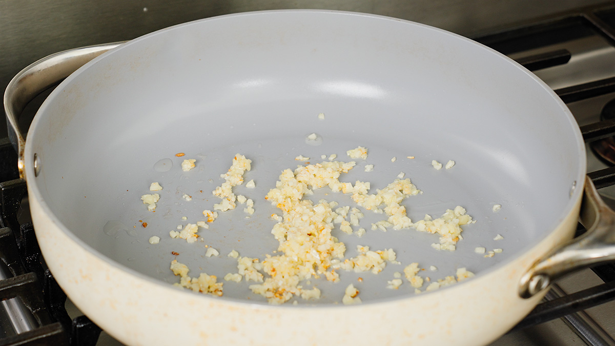 Cooking the aromatics in the large pan on the stove.