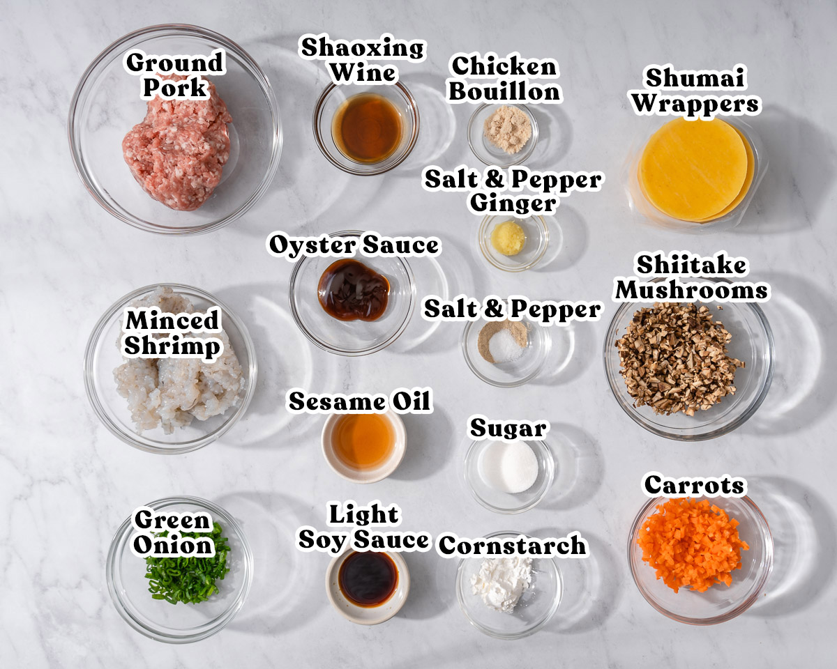 All the ingredients to make cantonese shumai organized and labeled in bowls.