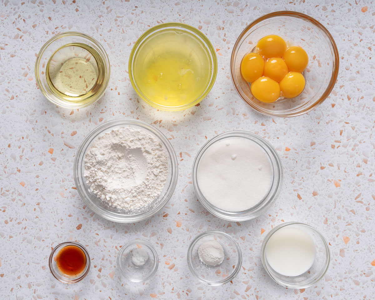 All the ingredients to make a chiffon cake organized in small glass bowls.