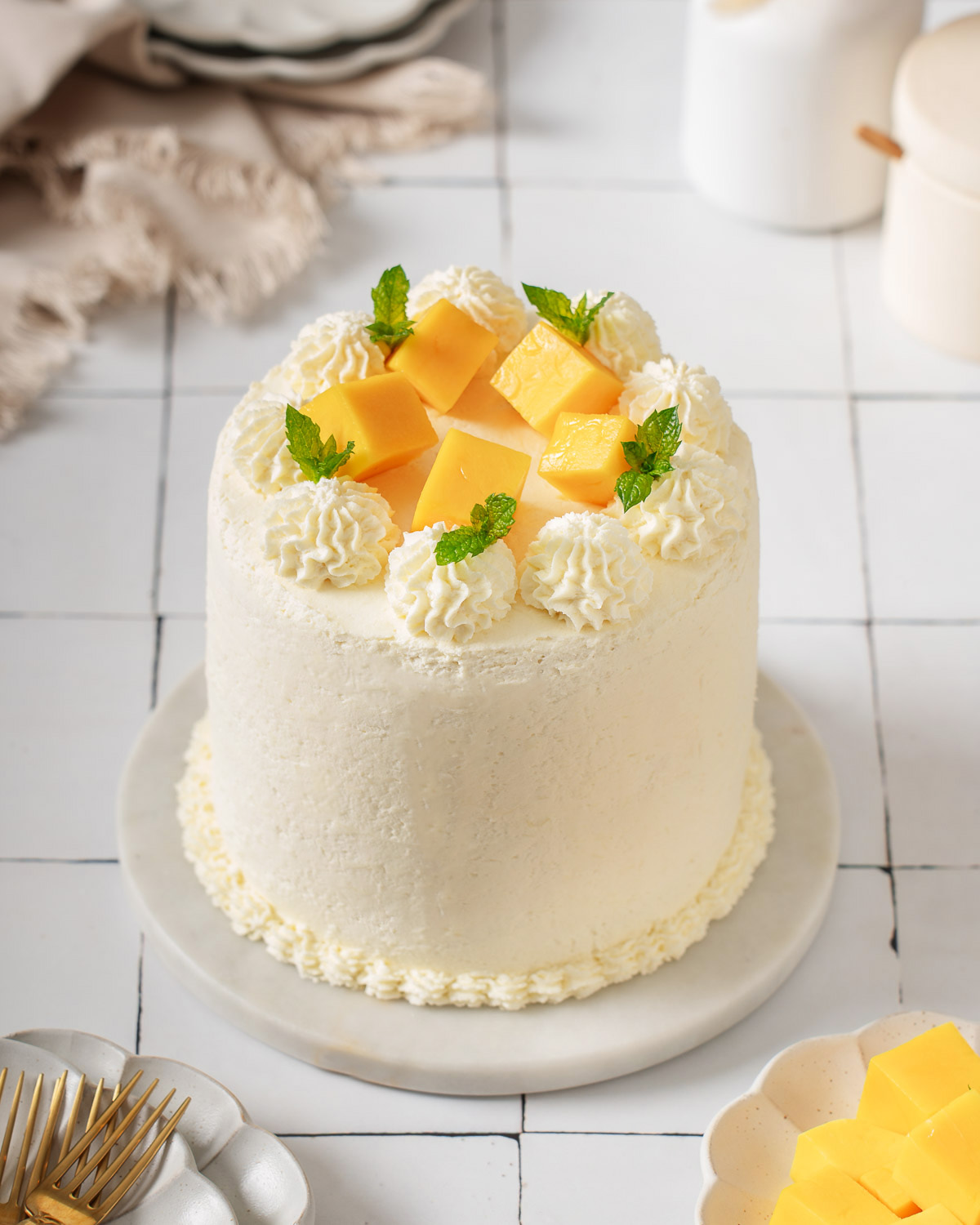 A mango cake sitting on a tiled counter.