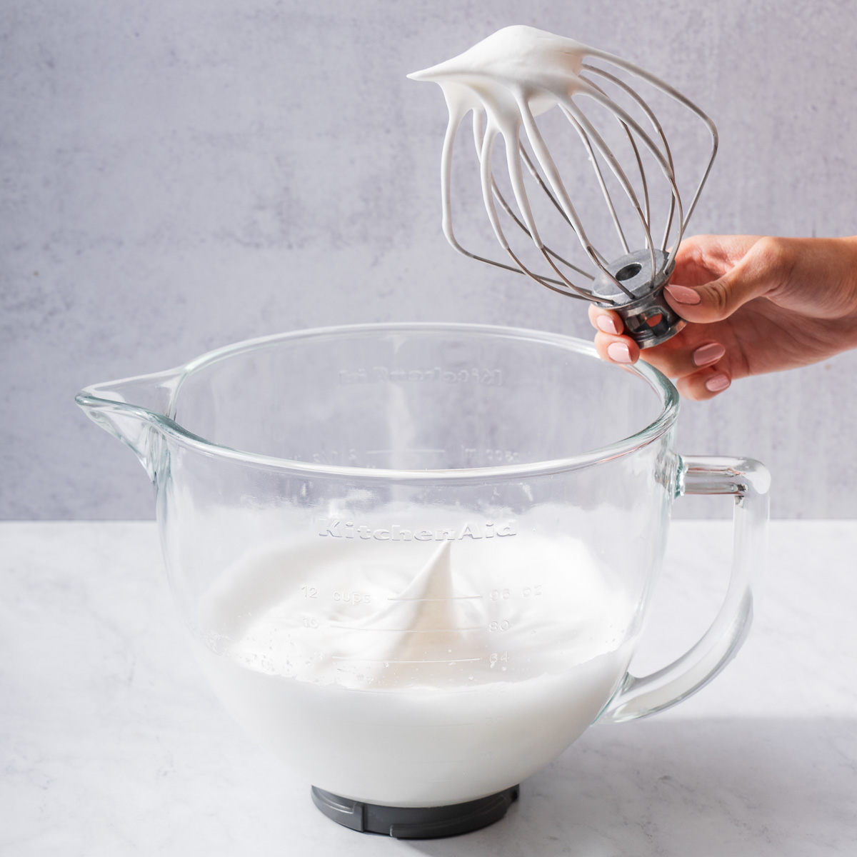 Meringue with stiff peaks on a mixer attachment.