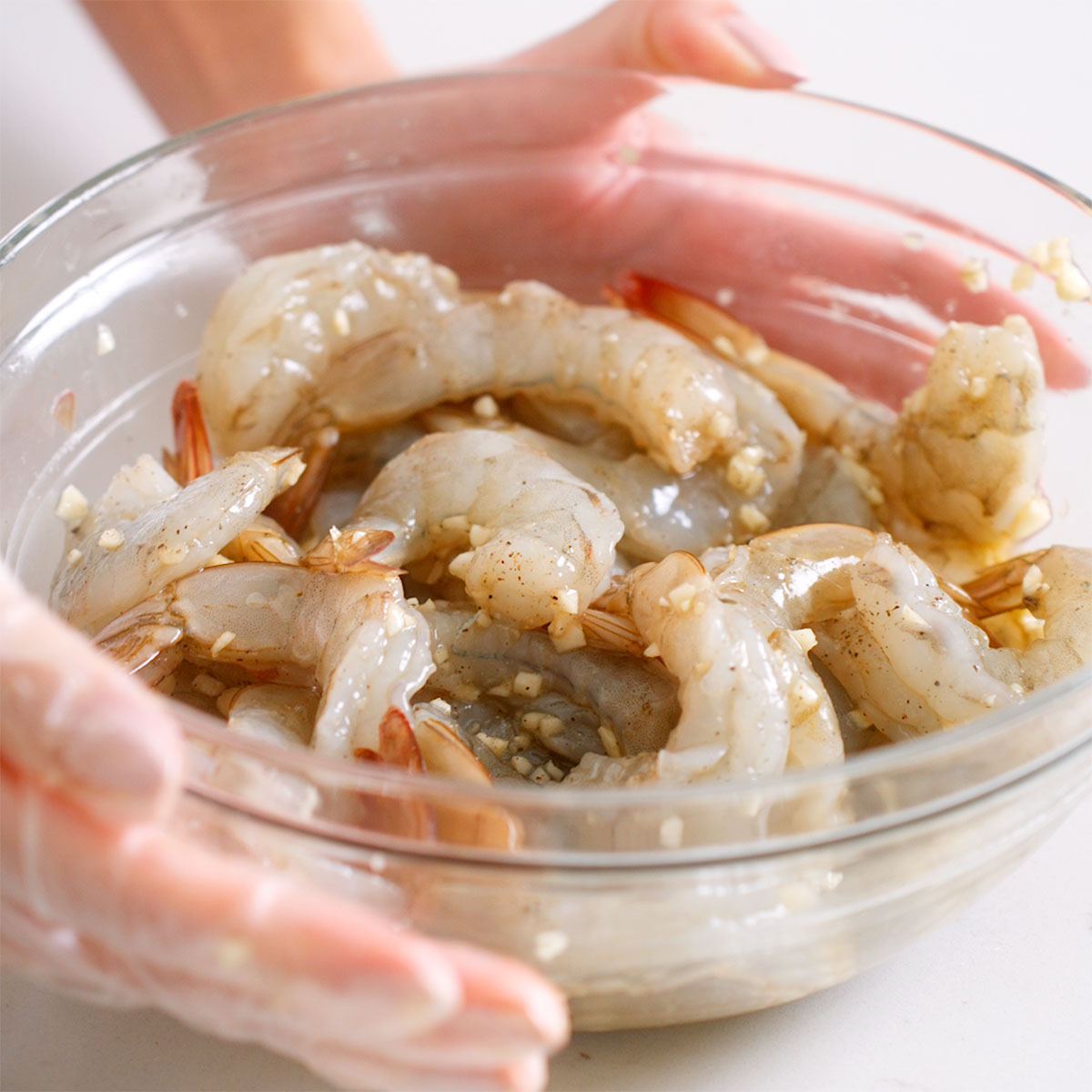 Shrimp seasoned with garlic and more in a large bowl.