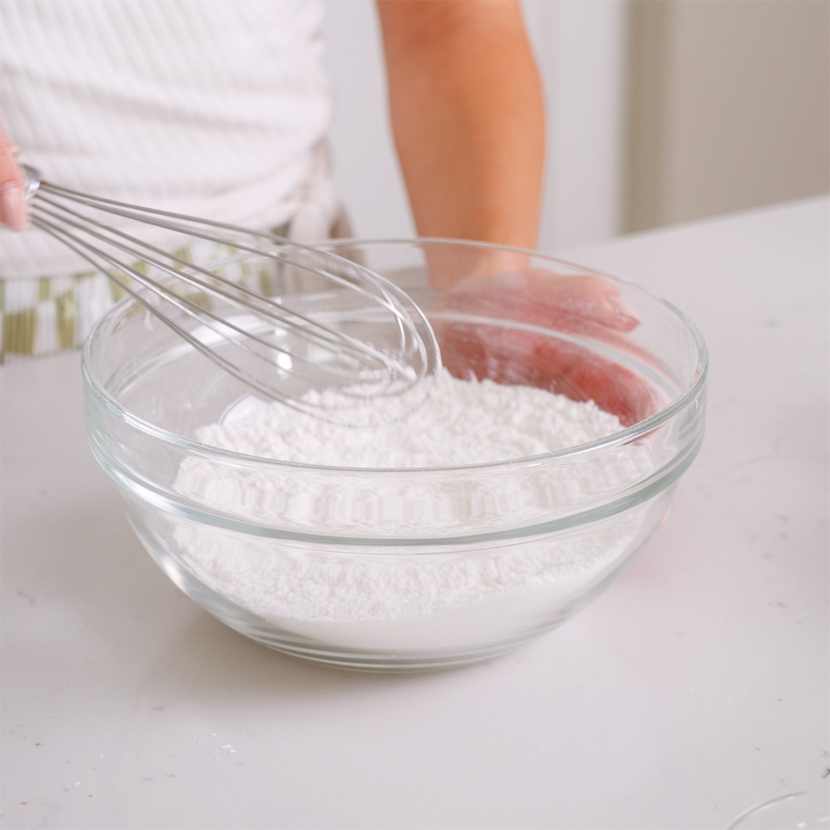 Whisking together sifted dry ingredients.