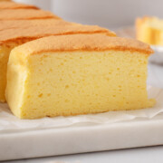 Slices of Taiwanese castella cake on a marble serving board.
