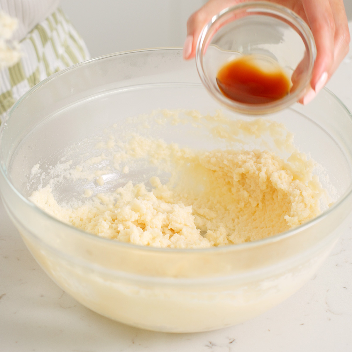 Adding vanilla extra to a flour and butter mixture.