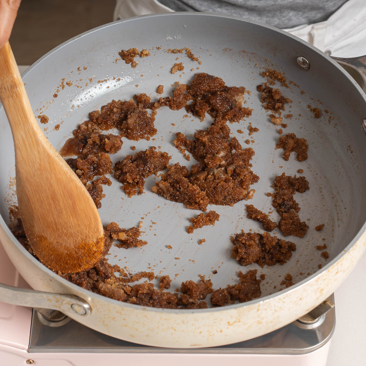 Cooking spices with butter in a deep skillet.