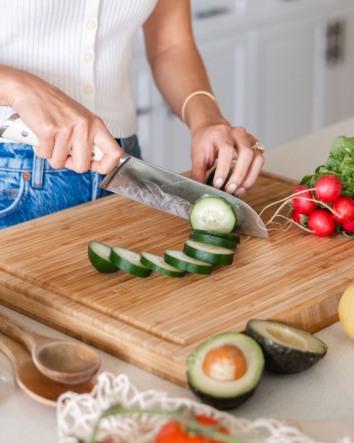 A detail shot of Megan slicing up a cucumber for a recipe.