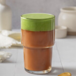 A glass of vietnamese coffee topped with matcha foam.