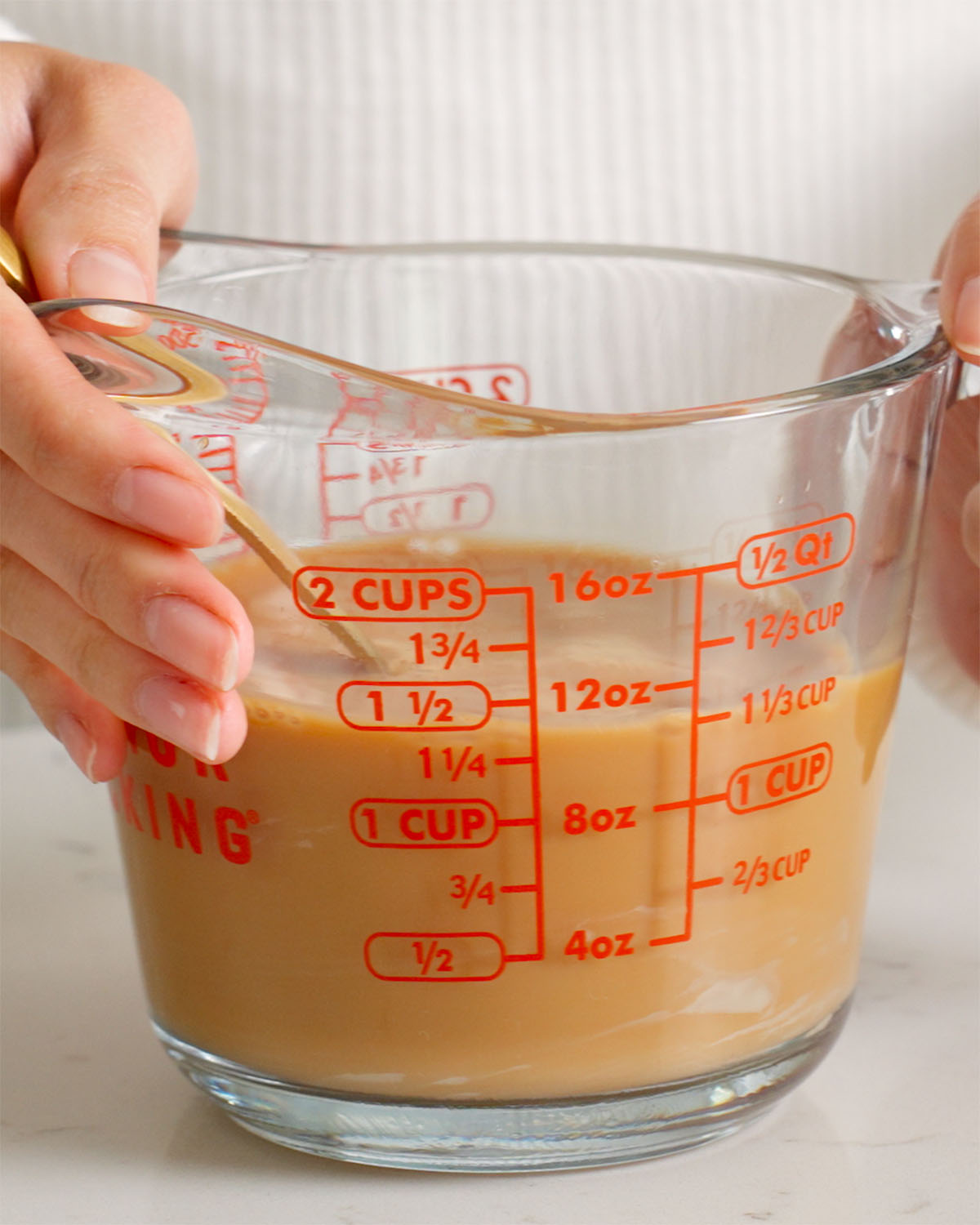 A measuring cup full of Vietnamese coffee.