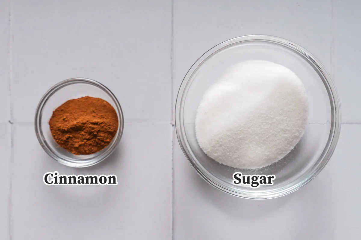 Cinnamon and sugar in small glass bowls.