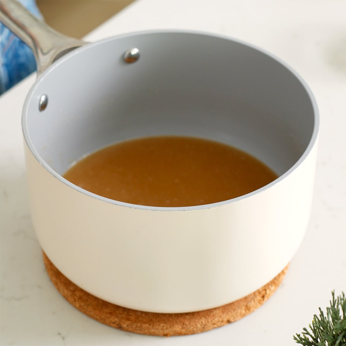 The wet ingredients for sesame cookies in a sauce pan resting.