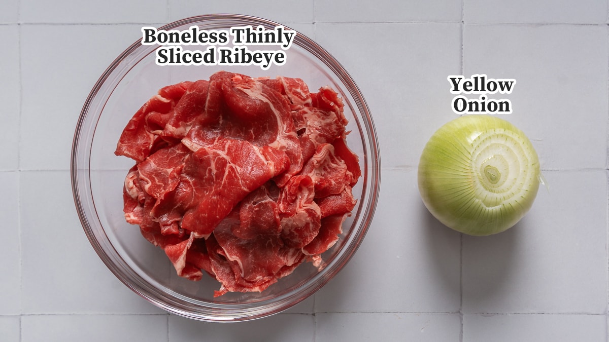 Thin sliced beef and a yellow onion for making beef bulgogi.