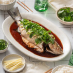 A table spread featuring a Chinese steamed fish.