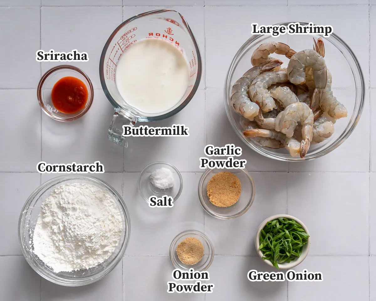 All the ingredients for making bang bang shrimp organized in bowls and labeled.