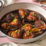 Chicken adobo served in a large braiser.