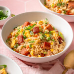 A few bowls of spam fried rice on a bright tiled surface.