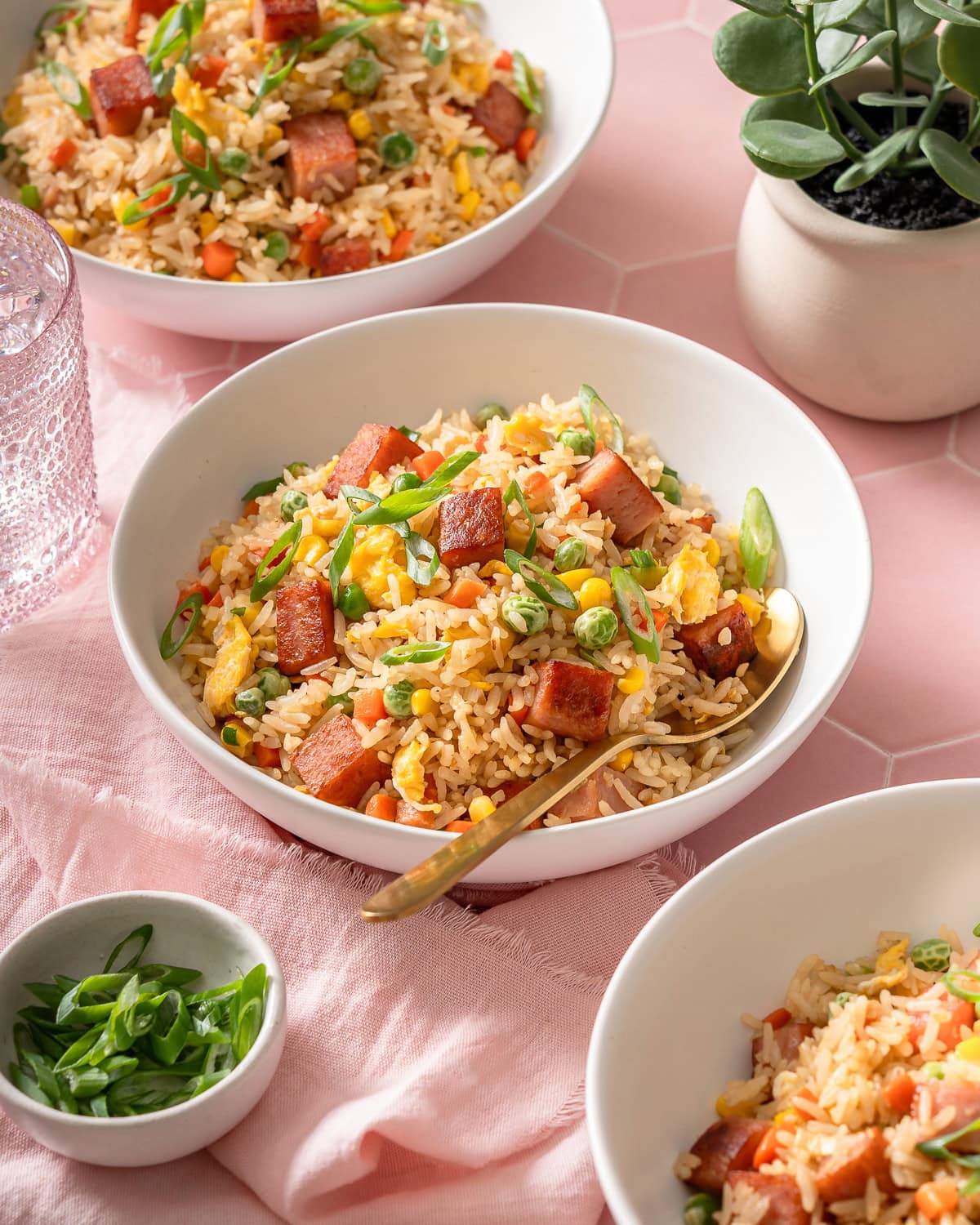 A few bowls of spam fried rice on a tiled surface.