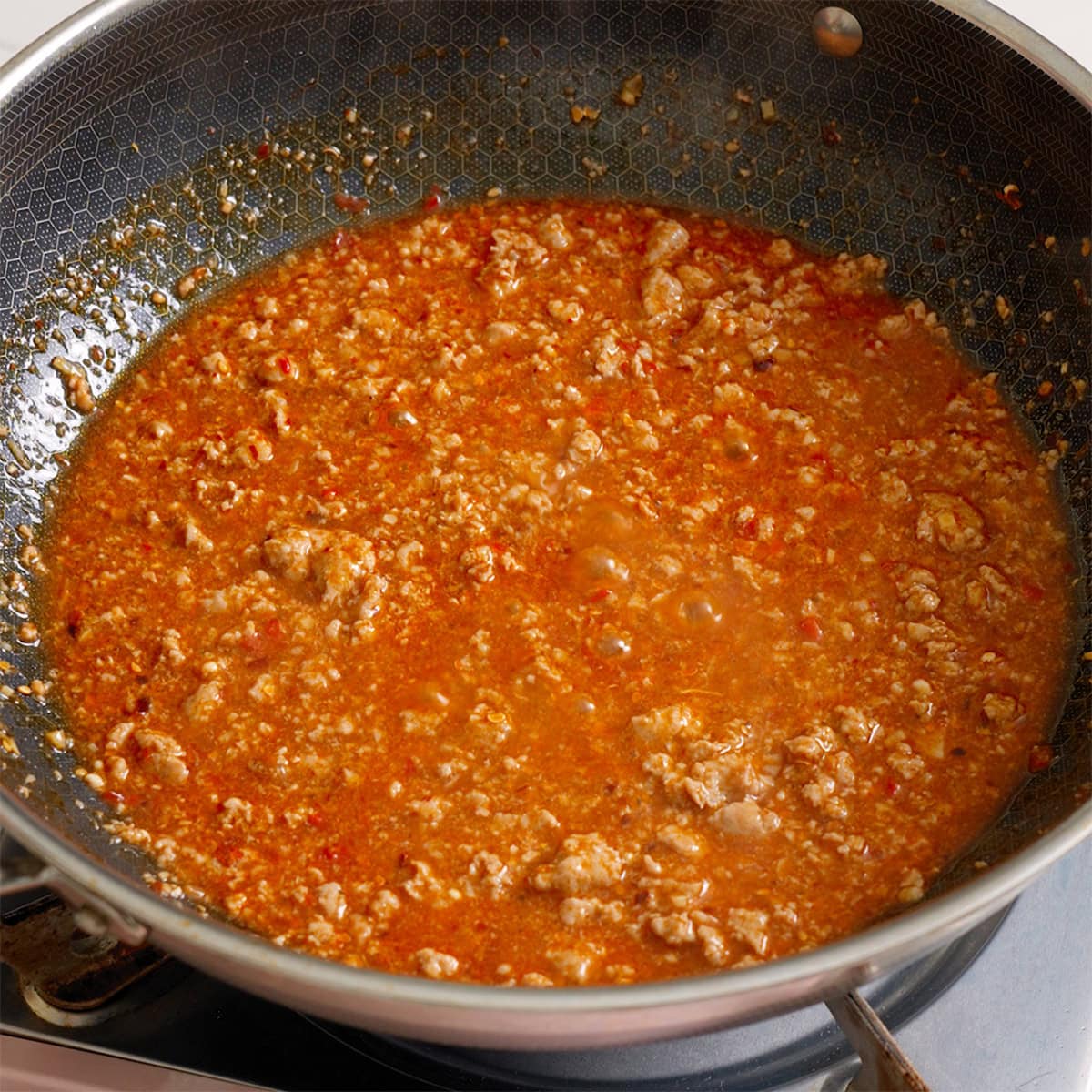 The pork mapo sauce thickened in a large wok.