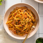 A top down view of a plate of spaghetti neopolitan.