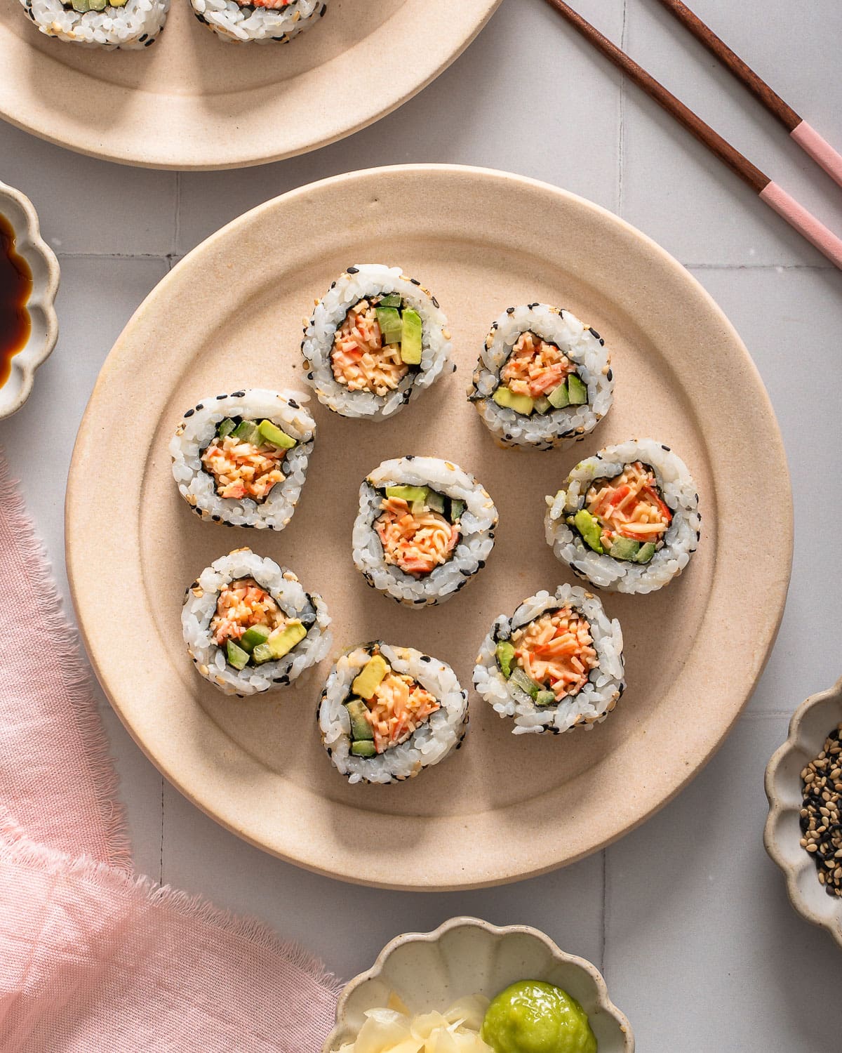 A top down view of a plate of spicy crab rolls.