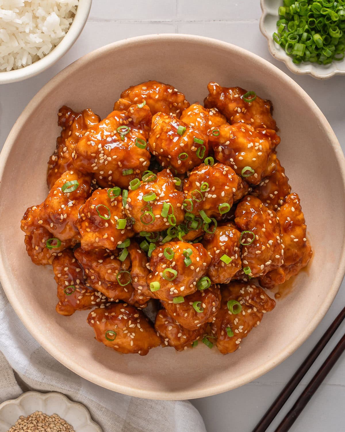 A top down view of plate of honey sesame chicken.