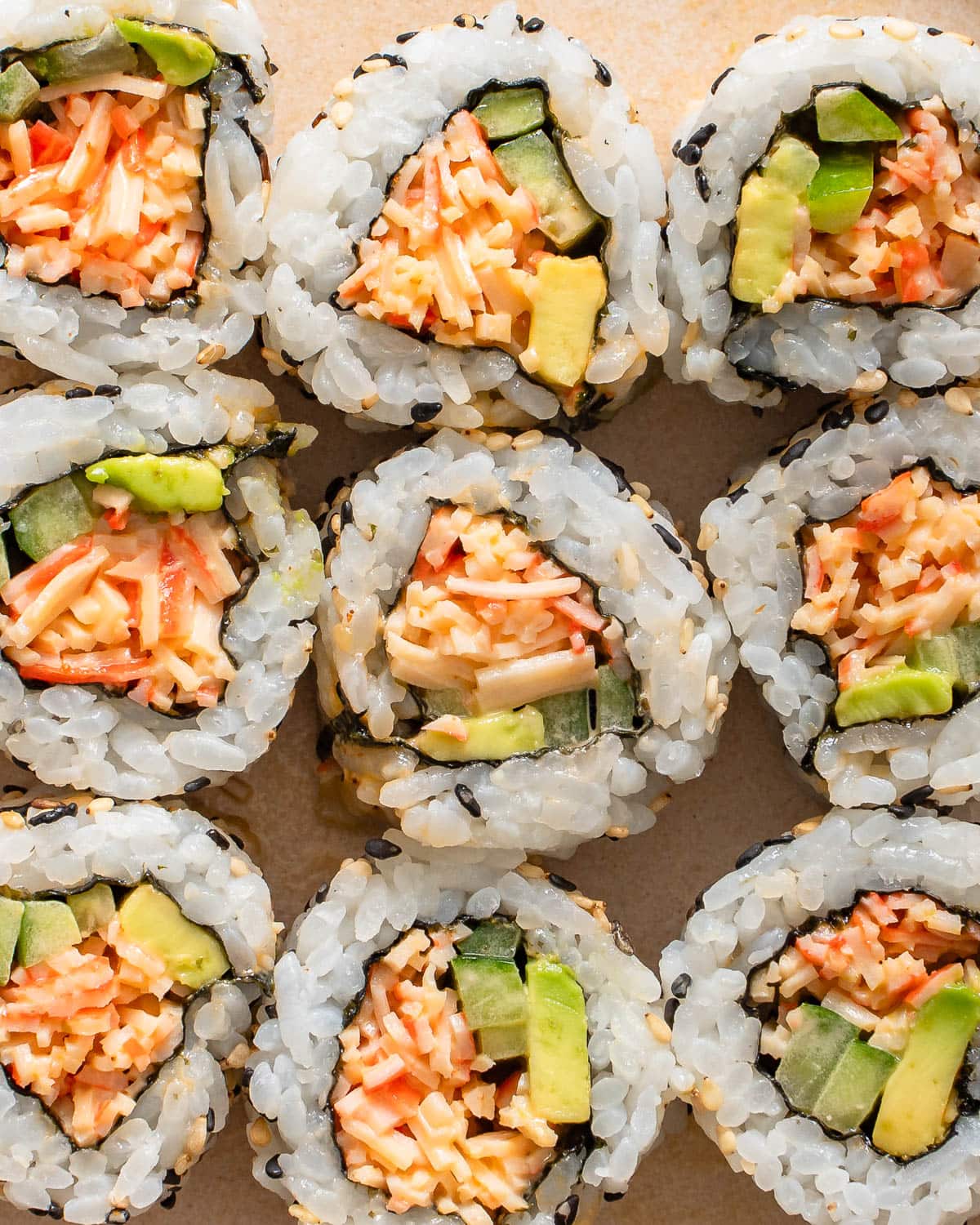 A detail shot of a grid of sushi rolls.