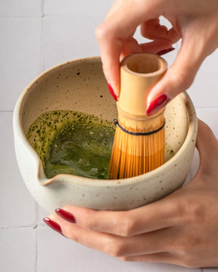 Whisking matcha in a matcha bowl.