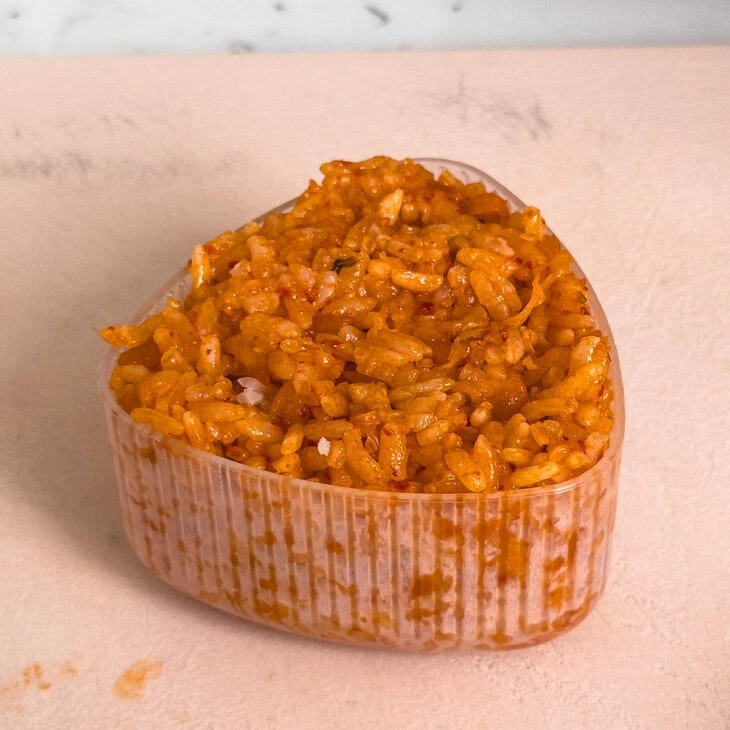 A kimchi rice ball packed inside an onigiri mold.