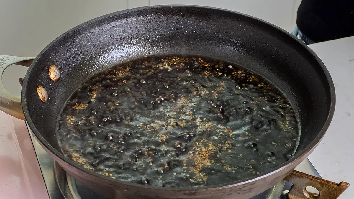 Preparing teriyaki sauce in a large skillet.