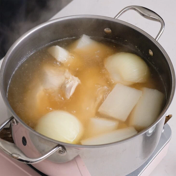 A pot of Vietnamese chicken broth simmering.