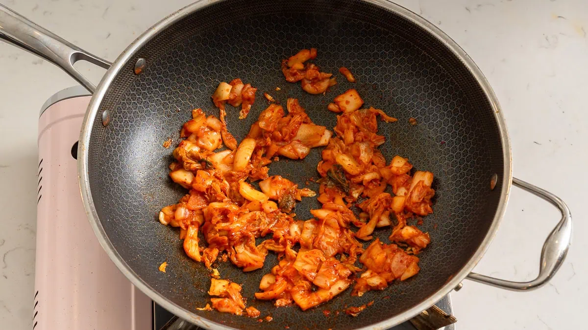 Cooking kimchi in a wok.